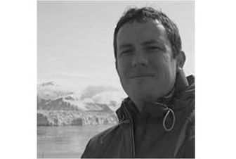 A man standing in front of a mountain